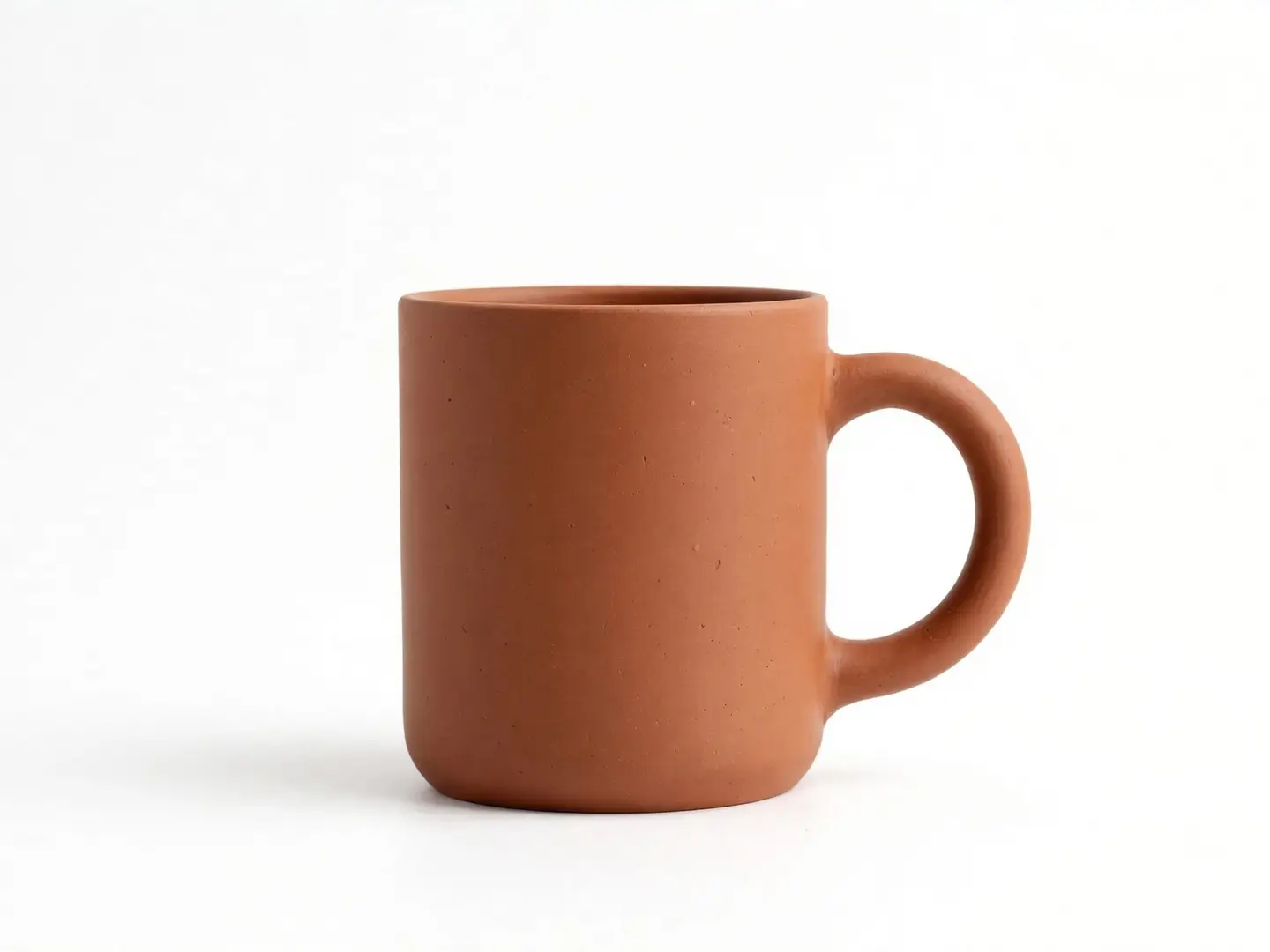 An AI-generated terracotta ceramic mug on a plain white studio background