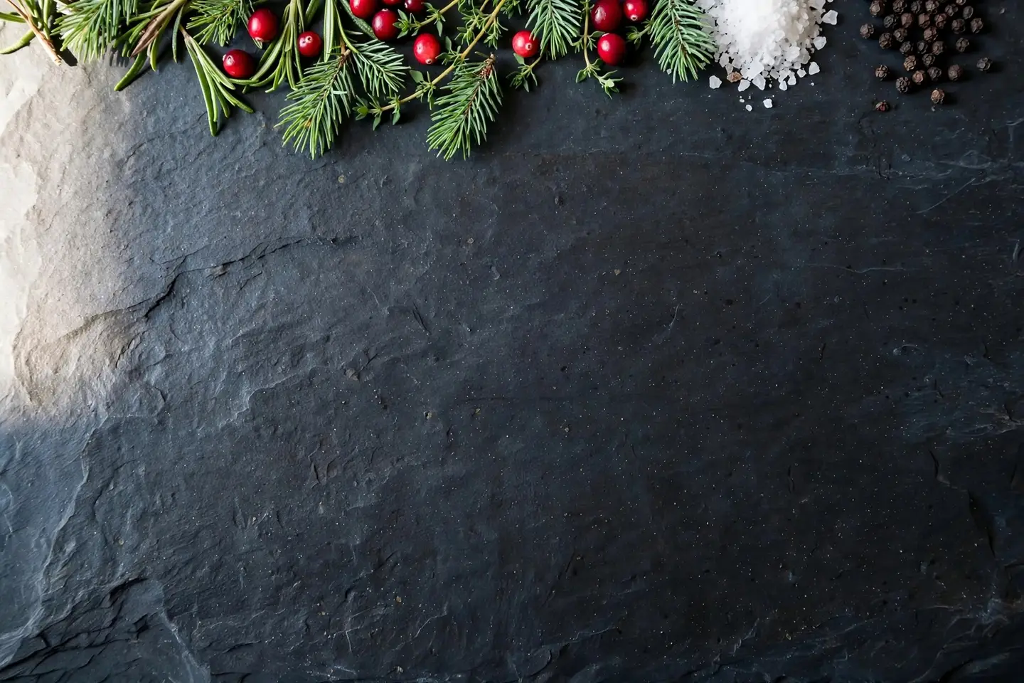 The same AI slate background after Edit by prompt, now with pine sprigs and red cranberries among the herbs along the top edge