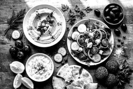 A table of mezze dishes with the Noir filter, after editing