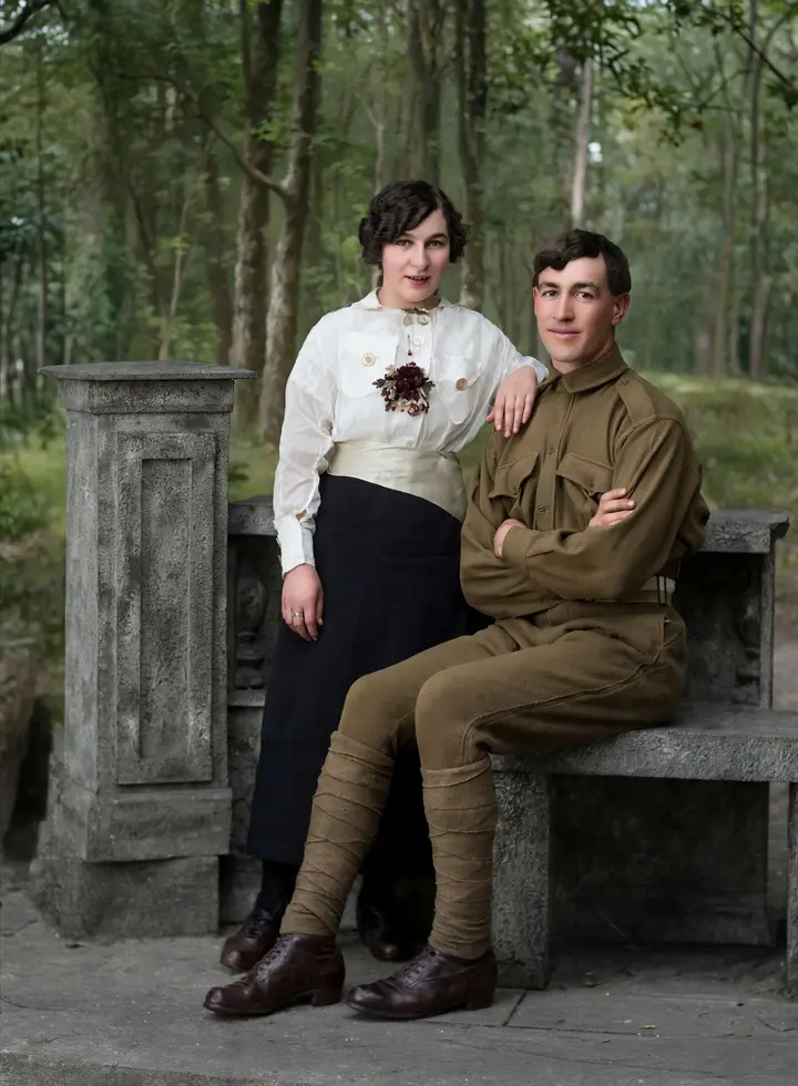 A soldier and a young woman posing on a stone bench, restored in real-life color