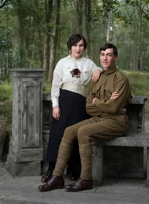 A soldier and a young woman on a stone bench: real-life color