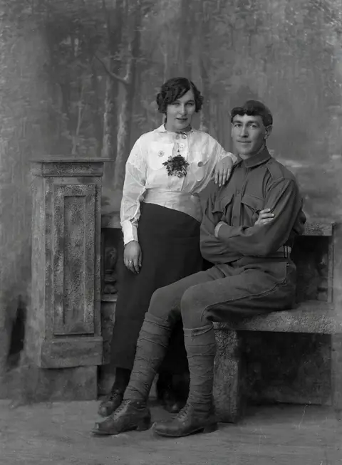 A soldier and a young woman on a stone bench: restore
