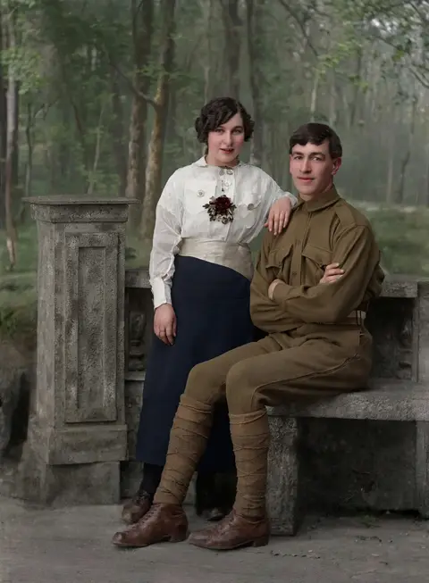 A soldier and a young woman on a stone bench: vintage color